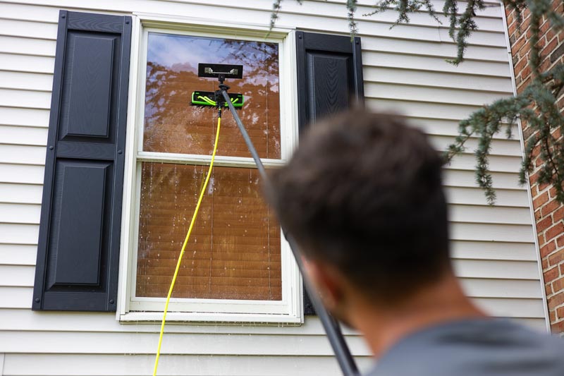 Cleaning the window of a home in Berks County, PA