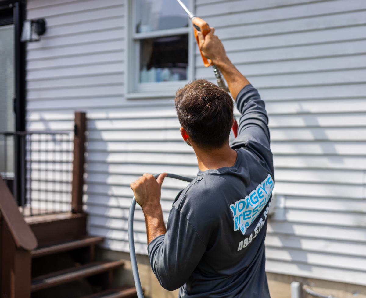 Owner Landon Yorgey rinsing a home