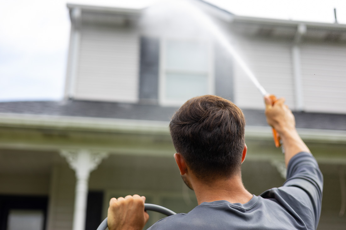 Landon Yorgey spray-rinsing a roof