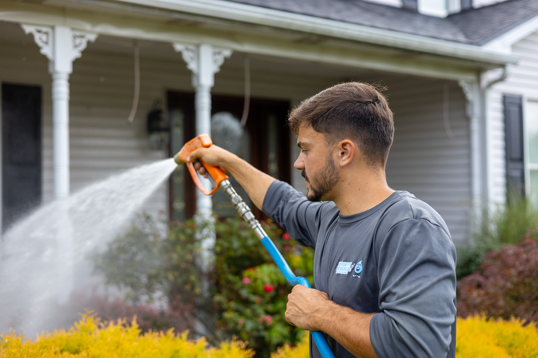 Owner Landon Yorgey rinsing plants to protect them from harsh chemicals